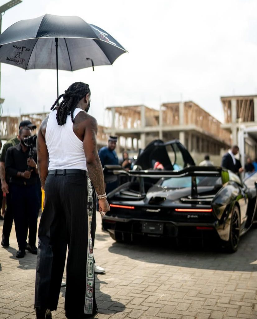 Photo of Burna boy looking at his new McLaren Senna